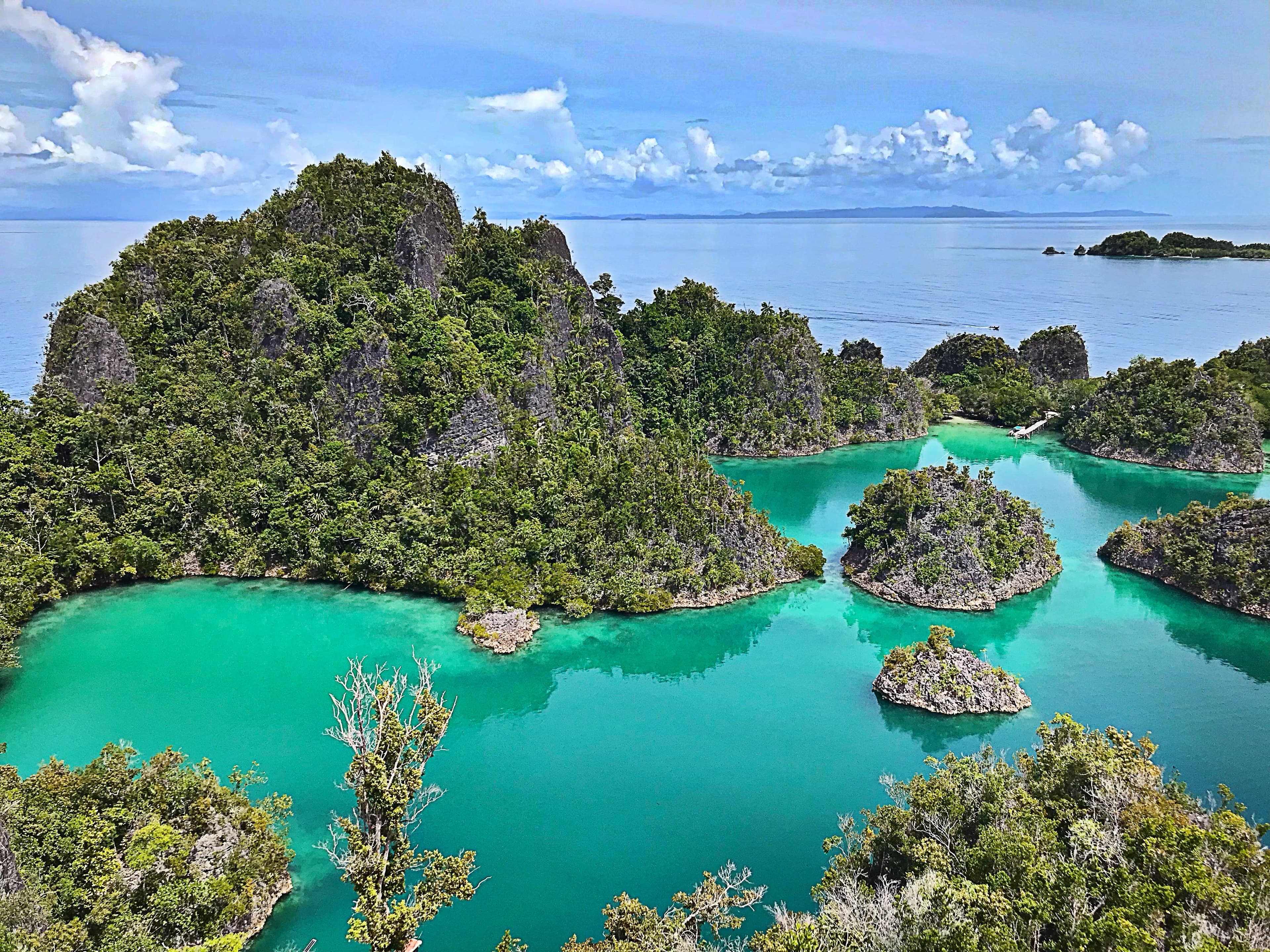 Islands scattered across a turquoise lagoon seen from above