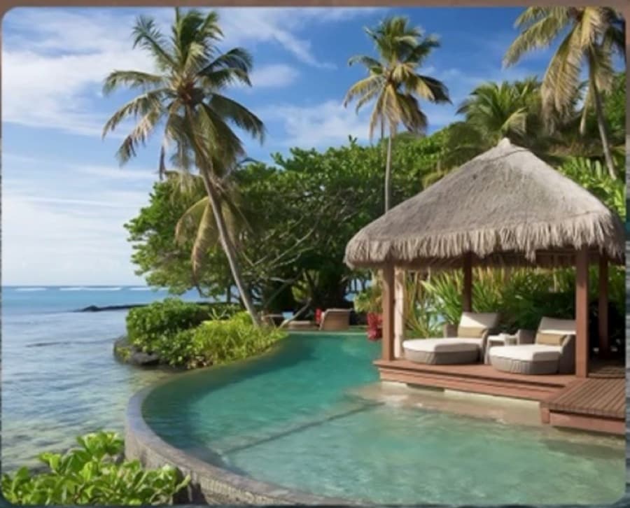 A thatched pavilion beside a curved pool
