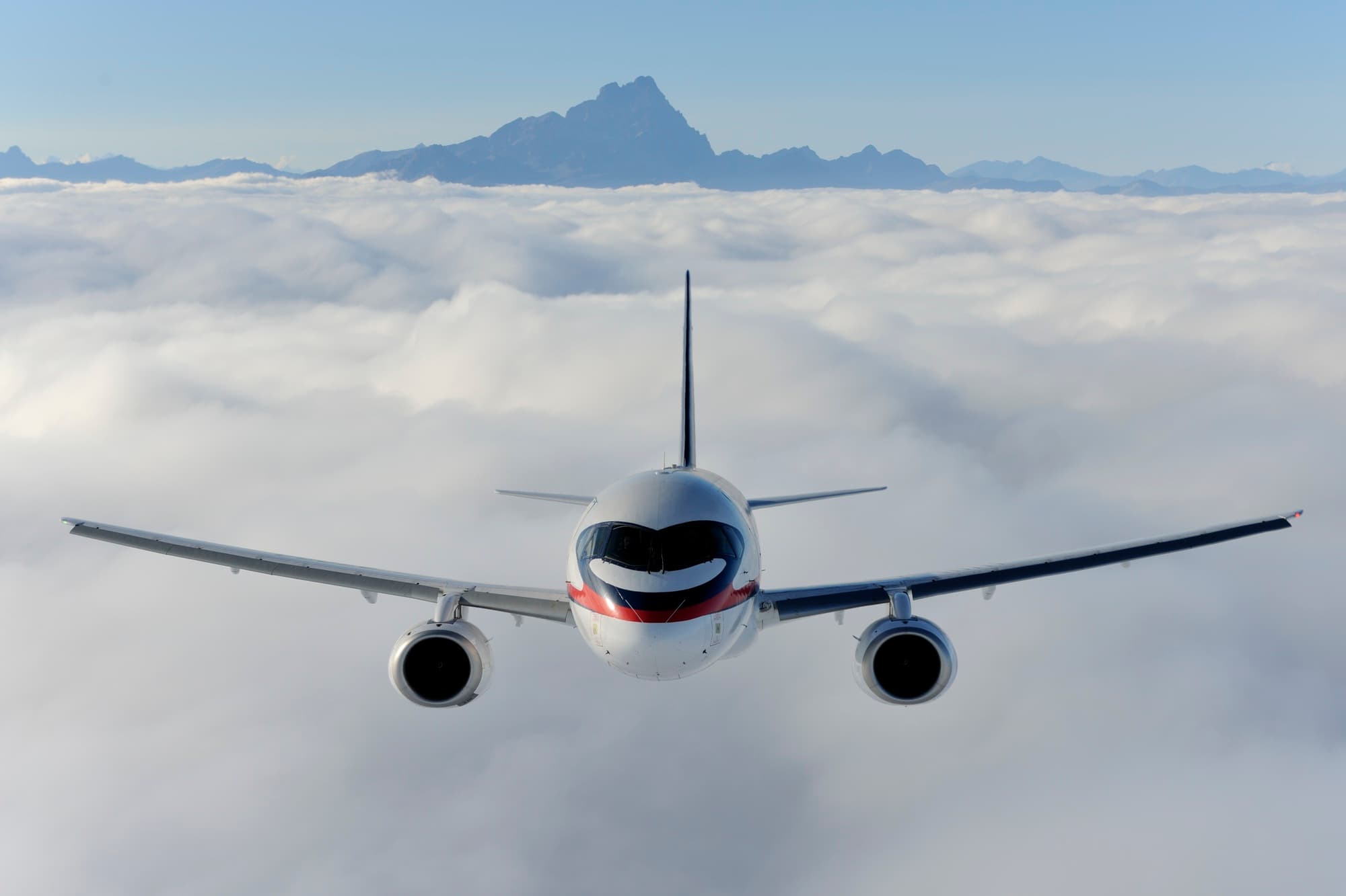 An airliner above a layer of cloud