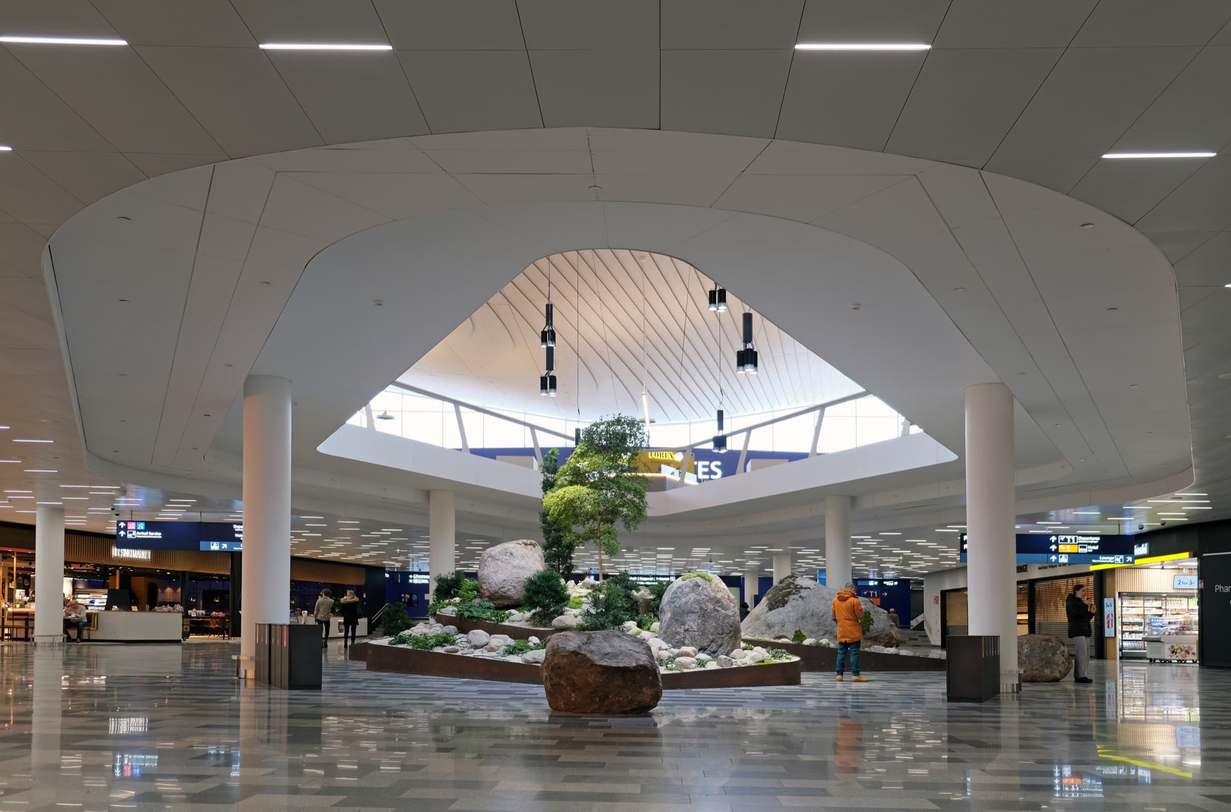 A modern airport concourse lit at night